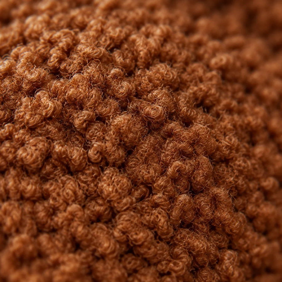 An extreme macro photograph of the caramel teddy bouclé wool from the upper of reference r13, with n