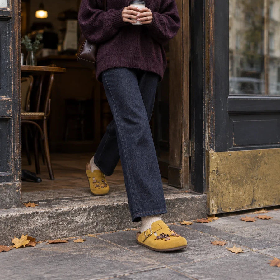 A square photograph of the mustard suede BIRKROCS mule from the reference, worn at real foot scale w